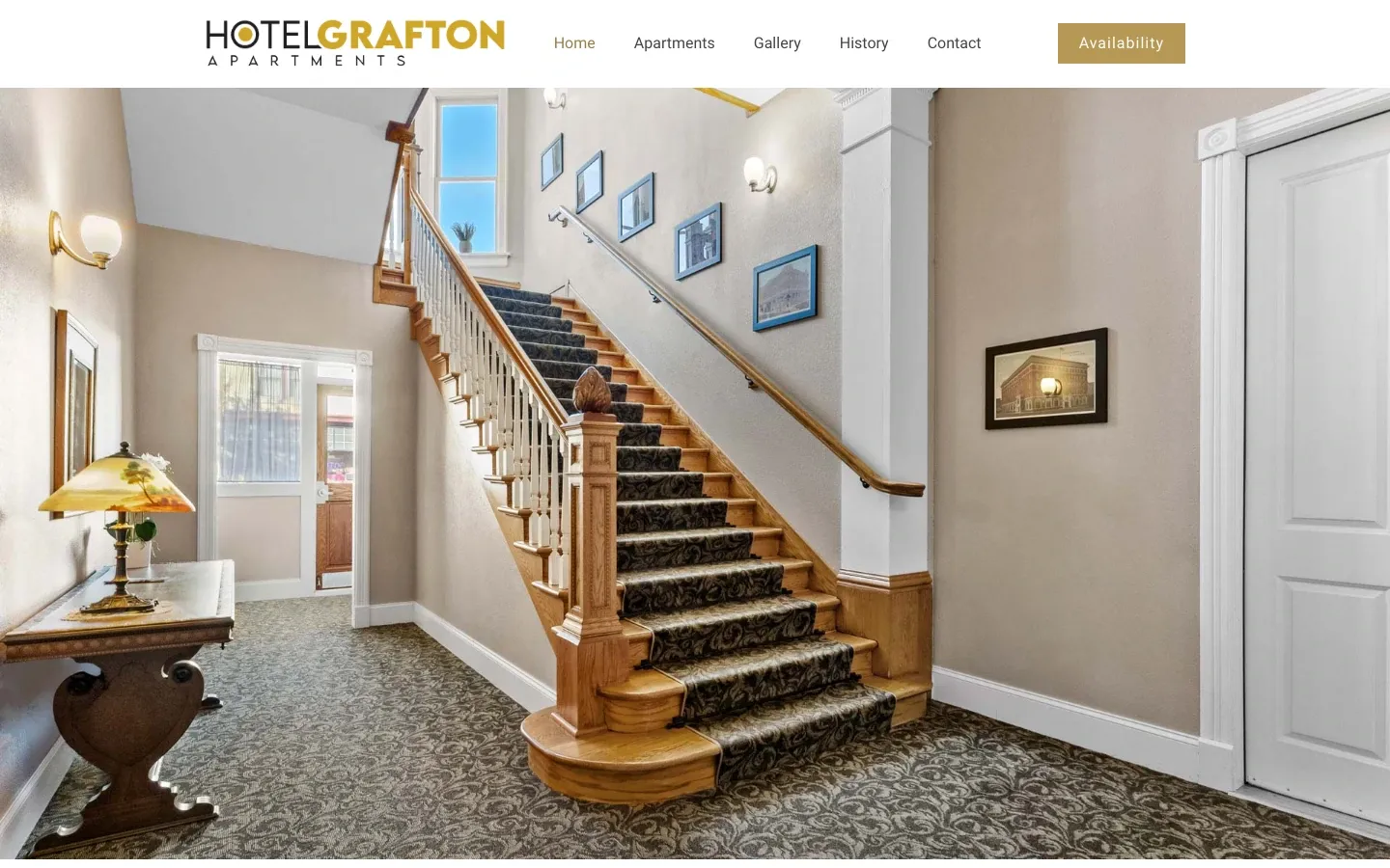 Hotel Grafton Apartments website on a laptop